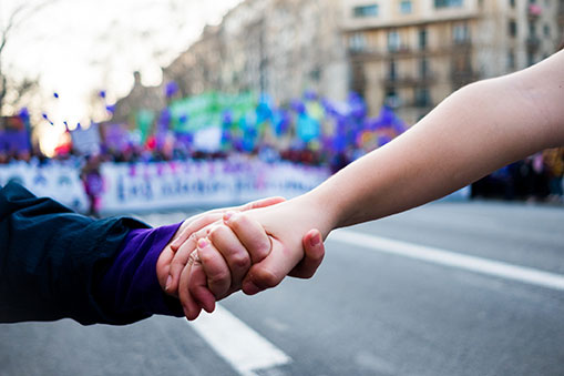 Two women holding hands