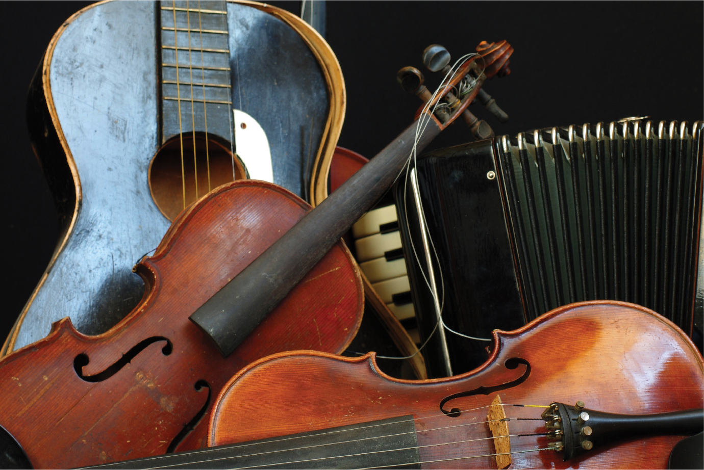 A picture of a guitar and two violins.