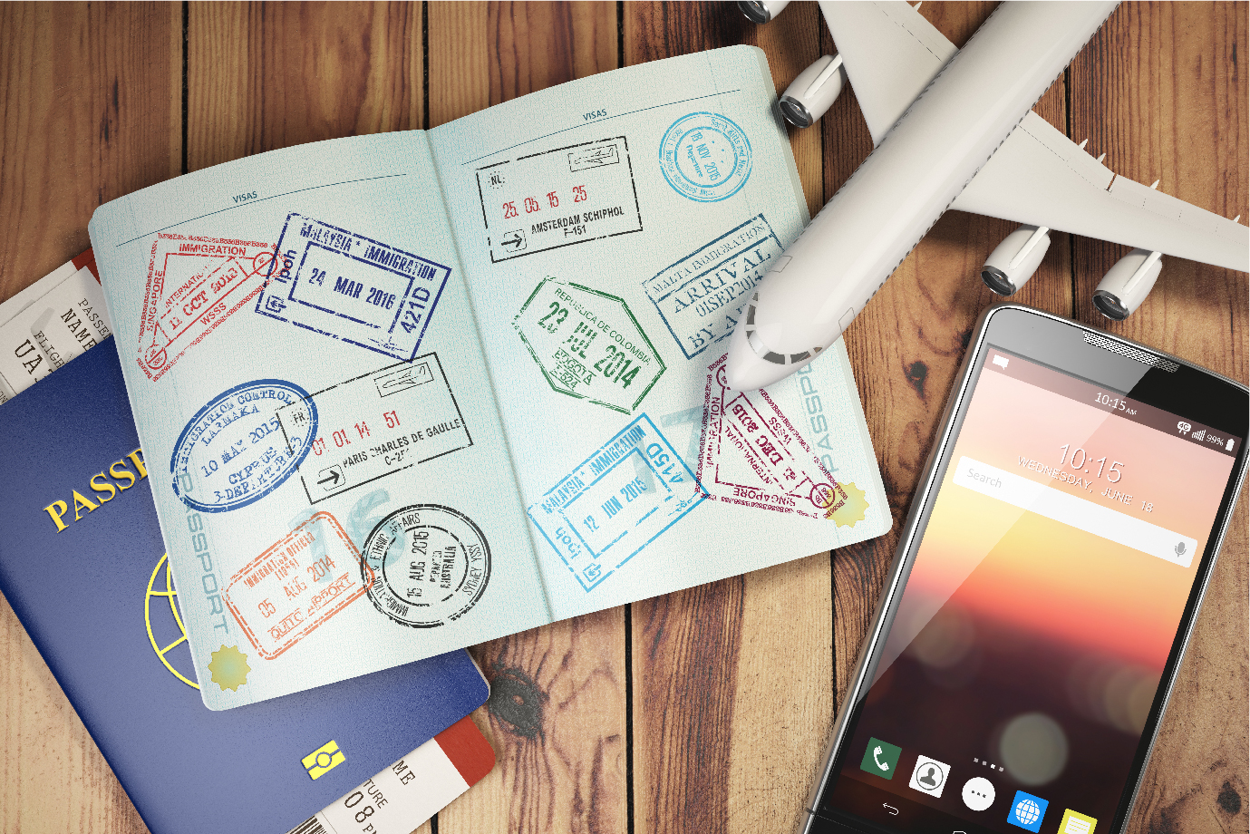 A picture of passports, a cellphone and a model airplane