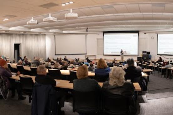 Prospective OLLI students attending a course preview in a lecture hall