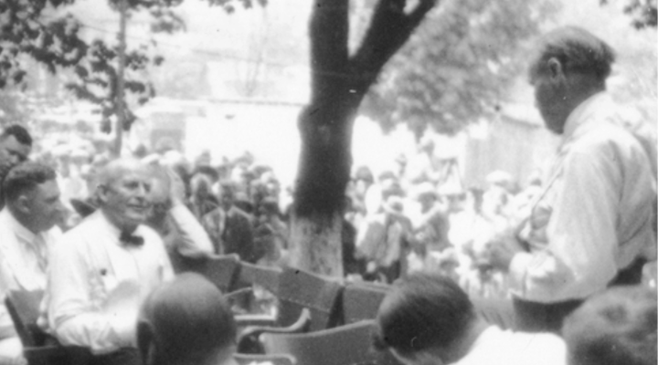 black & white photo of a group of men talking