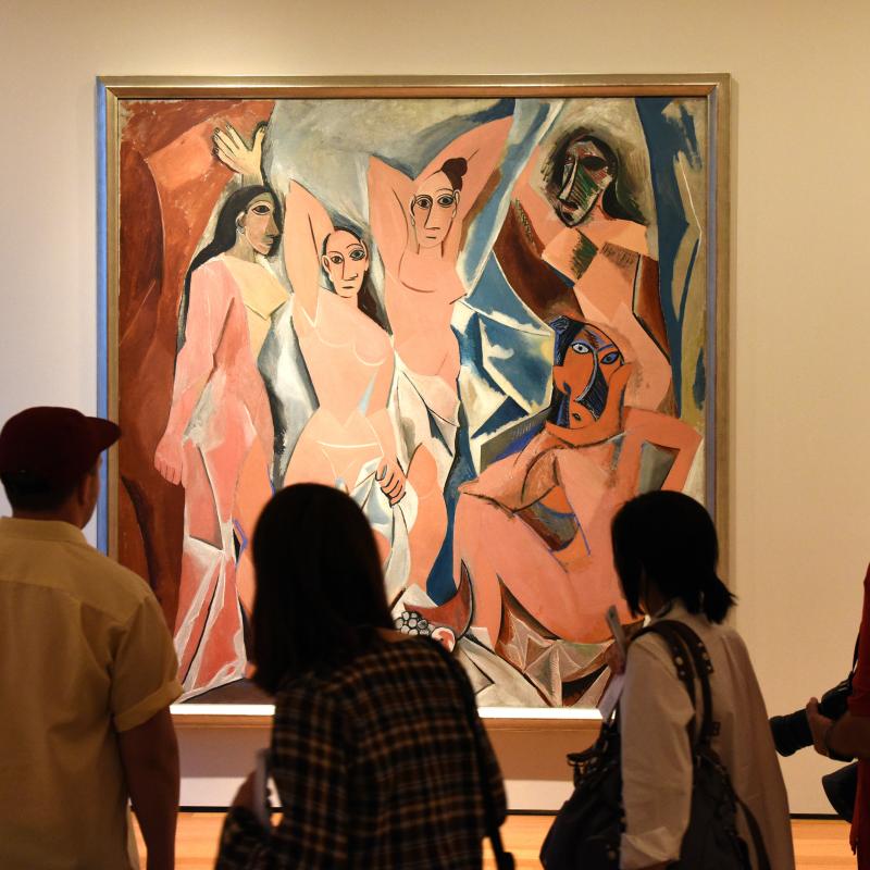 people in art gallery viewing a Futurism painting