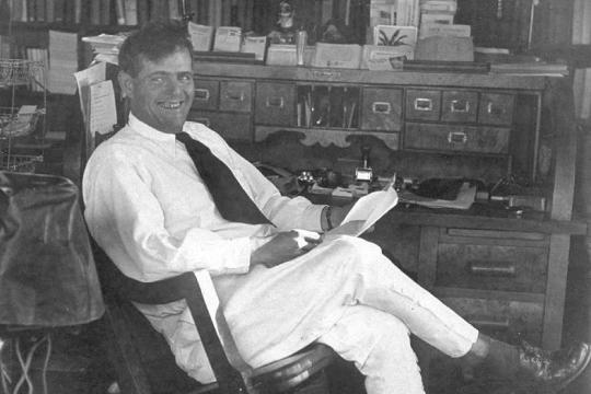 A black and white picture of Jack London reclining in a chair