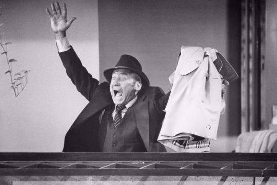 A black and white picture of Mel Brooks waving his hand