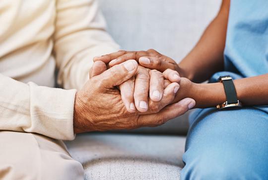 close up of two people holding hands